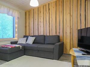a living room with a couch and a television at Holiday Home Hilla b by Interhome in Saariselka