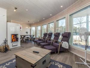 a living room with a couch and a fireplace at Holiday Home Riemukaari by Interhome in Lihavanpää