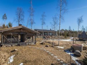 a log cabin in the middle of a forest at Holiday Home Riemukaari by Interhome in Lihavanpää