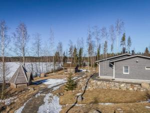 a home in the woods with snow on the ground at Holiday Home Riemukaari by Interhome in Lihavanpää