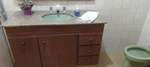 a bathroom with a sink and a toilet at Quarto Suíte Amora in Atibaia +17 photos