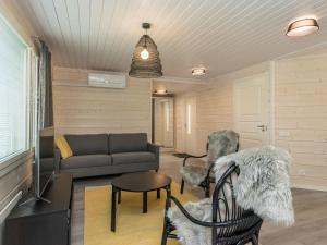 a living room with a couch and a table and chairs at Holiday Home Valonsäde by Interhome in Valkeala +14 photos