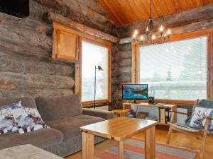 a living room with a couch and a table at Holiday Home Sallanhelmi e2 by Interhome in Salla