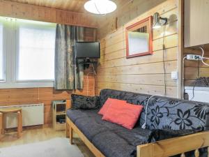 a living room with a couch and a tv at Holiday Home Lomamaja 3 by Interhome in Raattama