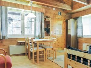 a dining room with a table and chairs at Holiday Home Lomamaja 3 by Interhome in Raattama