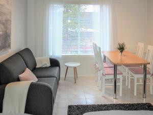 a living room with a couch and a table at Holiday Home Kanerva 202 by Interhome in Äkäslompolo +8 photos