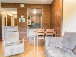 a living room with a couch and a table at Holiday Home Ylläs chalets a507 by Interhome in Ylläsjärvi