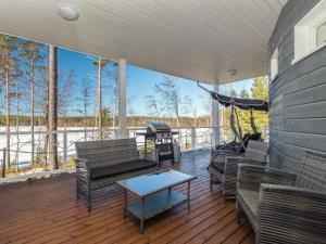 a living room with chairs and a hammock on a deck at Holiday Home Paula by Interhome in Lihavanpää