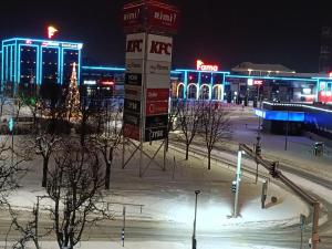 a city at night with a christmas tree and buildings at Energia 2 Apartment in the city center in Narva