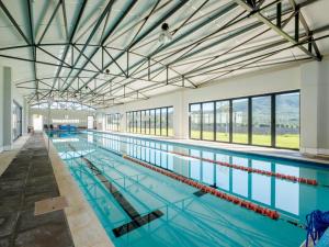 a large indoor swimming pool with blue water at Sempurna Estate in McGregor