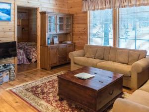 a living room with a couch and a coffee table at Holiday Home Ylläskaira a by Interhome in Äkäslompolo