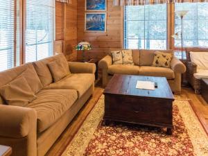 a living room with a couch and a coffee table at Holiday Home Ylläskaira a by Interhome in Äkäslompolo