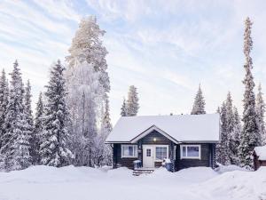 a cabin in the snow with snow covered trees at Holiday Home Isopyhänmaa by Interhome in Salla