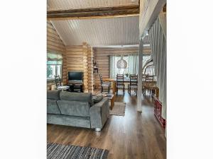 a living room with a couch and a dining room at Holiday Home Isopyhänmaa by Interhome in Salla +17 photos