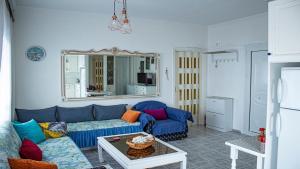 a living room with a blue couch and a table at Apartment 45m2 in Asprovalta in Asprovalta
