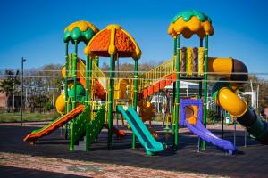 a playground with a colorful slide and slidesktop at AYBELYA TATİL KÖYÜ in Bafra