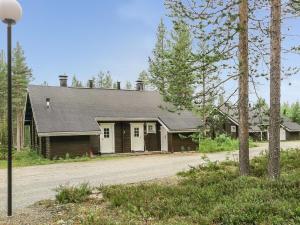 a house with a gambrel roof on a road at Holiday Home Kolonen by Interhome in Levi