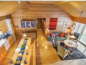 a living room with a couch and a table at Holiday Home Sinikuono by Interhome in Ylläsjärvi