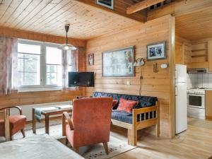 a living room with a couch and a table at Holiday Home Lomamaja 2 by Interhome in Raattama