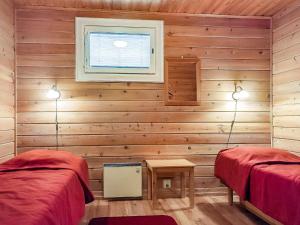 a room with two beds and a window at Holiday Home Lomamaja 2 by Interhome in Raattama +13 photos