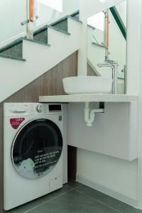 a washing machine in a bathroom with a sink at Biệt thự Hồ Tràm 3224 in Xuyên Mộc +24 photos