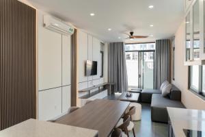 a living room with a table and a couch at Biệt thự Hồ Tràm 3224 in Xuyên Mộc