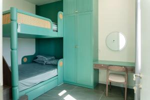 a bunk bed with a desk in a room at Biệt thự Hồ Tràm 3224 in Xuyên Mộc