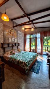 a bedroom with a large bed in a room at BaanRaiChayKhaoFarmStay in Nakhon Si Thammarat
