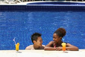 a man and a young girl sitting in a swimming pool at Casa Blue Hotel All Inclusive in Bodrum City