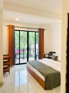 a bedroom with a bed and a balcony at Ella 78 Resort in Ella