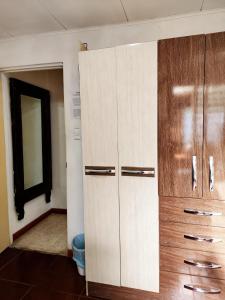 a closet with wooden cabinets in a room at Casa Kitus in San José +70 photos
