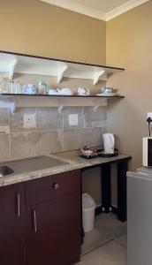 a kitchen with a counter and a counter top at The Anne Guest House in Maseru +40 photos