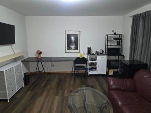 a living room with a desk and a couch at Bujaks in Inuvik