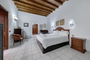 a bedroom with a bed and a desk and a chair at La Casucha - Typical Canarian House By Lanzarote Vacation Homes in Tías