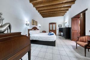 a hotel room with a bed and a piano at La Casucha - Typical Canarian House By Lanzarote Vacation Homes in Tías +36 photos