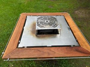 a microwave oven sitting on top of the grass at Geofond Chaty in Chotěboř