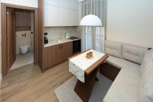 a kitchen and living room with a couch and a table at Nordic Nest Kolašin in Kolašin +43 photos
