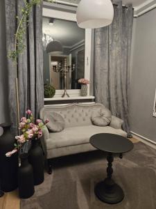a living room with a couch and a table at Gästezimmer vom Restaurant Saustall in Mestlin