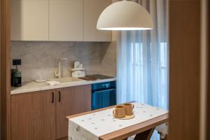 a kitchen with a table with two mugs on it at Nordic Nest Kolašin in Kolašin