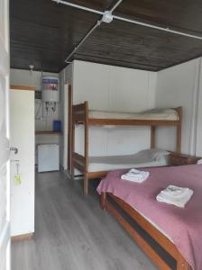 a bedroom with a bunk bed with a purple blanket at Cabañas del Rio in Gualeguaychú