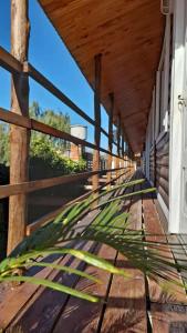 a wooden porch of a building with a wooden roof at Cabañas del Rio in Gualeguaychú