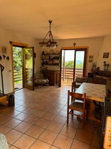 a living room with a table and chairs and a view at Baita del Silenzio in Miazzina