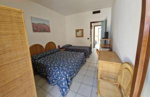 a hotel room with two beds and a table at Hotel Solara in Conca Specchiulla +21 photos