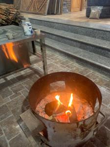 a pot with fire in it with a table at Đoàn Kết Homestay in Dồng Văn