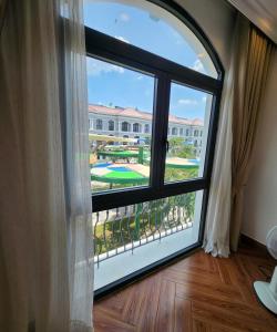 a window with a view of a campus at BREAKING DAWN- TAEYANG Hotel Phú Quốc in Phú Quốc