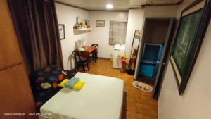 a living room with a white couch and a table at Kochimoto Homestay in Baguio