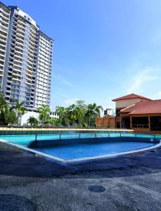 an empty swimming pool in front of some buildings at Homestay Tysha in Kampong Pulau Sebang