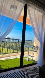 a room with a window with a view of the ocean at Homestay Tysha in Kampong Pulau Sebang