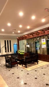 a lobby with two benches in a building at Homestay Tysha in Kampong Pulau Sebang +9 photos