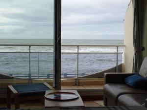 a living room with a view of the ocean at La GOELETTE in Quend-Plage +3 photos